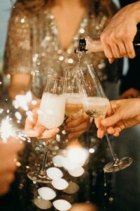 women celebrating with champagne for new year's achieving their goals and new year's resolutions